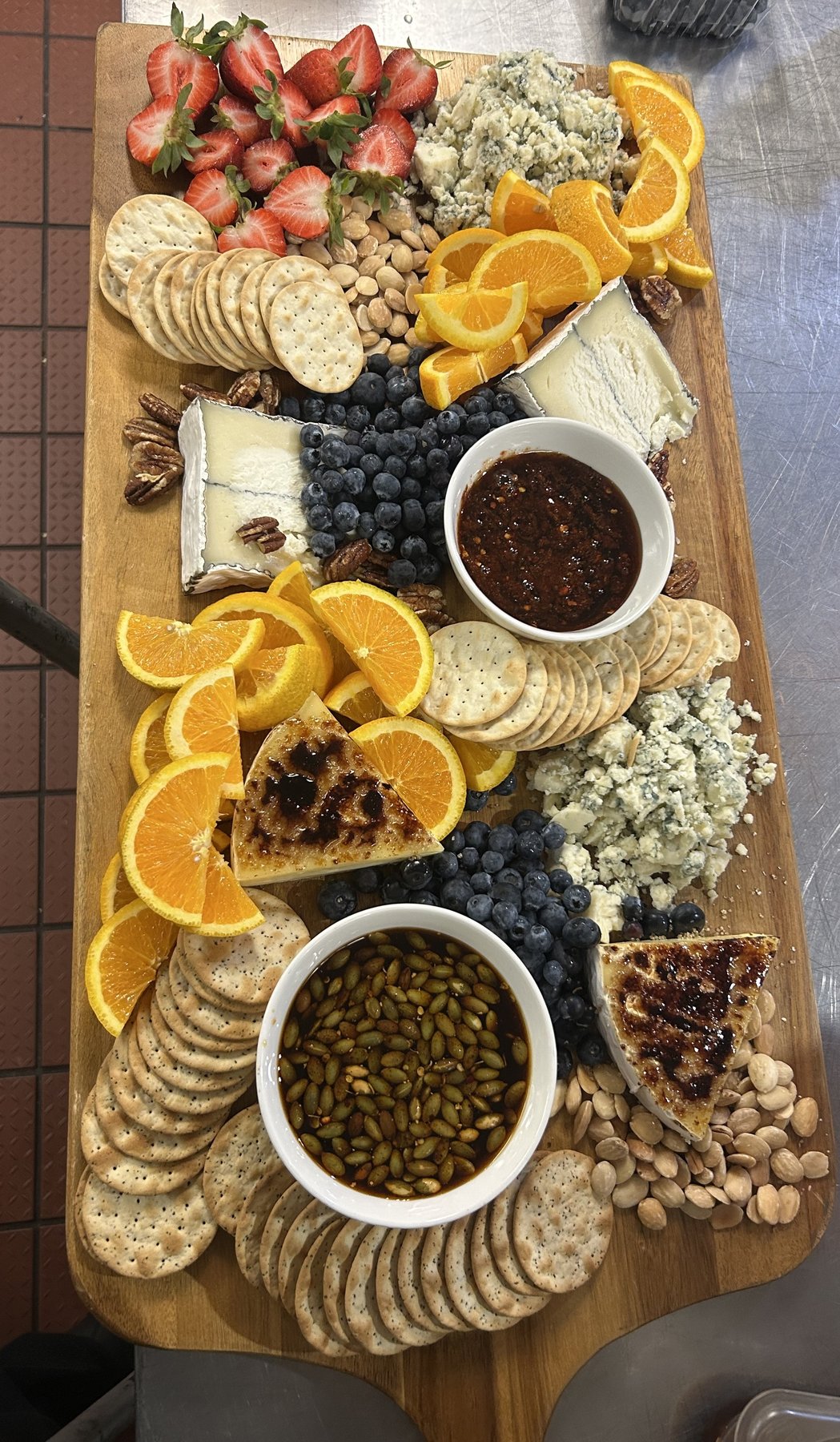 Oakmont catering spread with cheese, fruit, and honeyed accompaniments