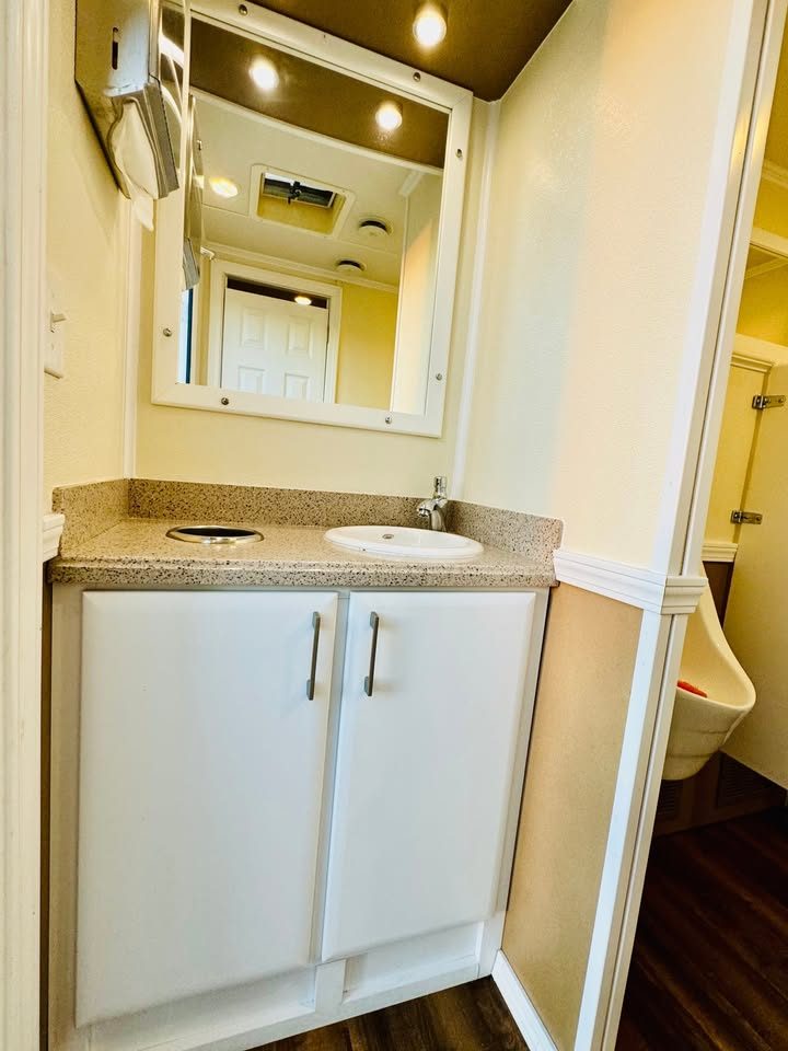 Interior sink and mirror inside the Oakmont restroom trailer